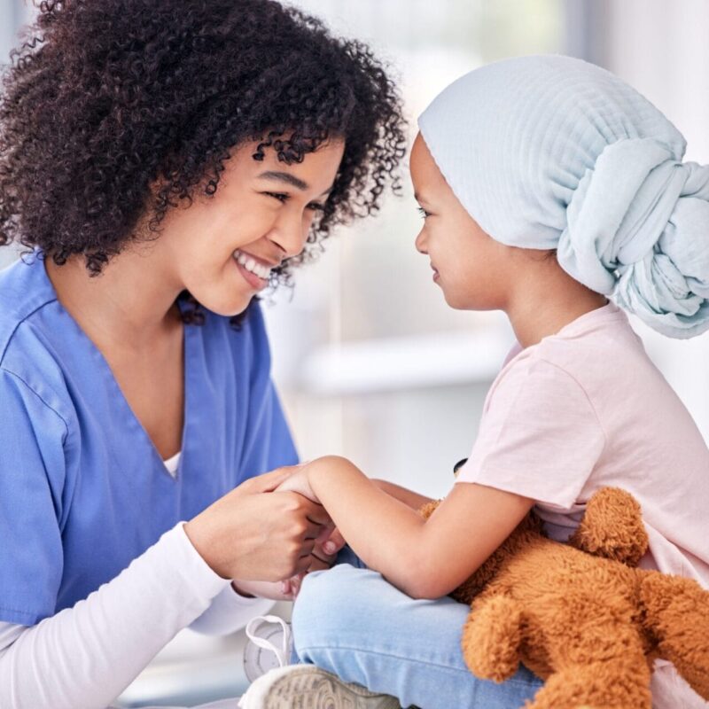 .support,,Nurse,And,Child,Holding,Hands,On,Bed,In,Hospital .support,,Nurse,And,Child,Holding,Hands,On,Bed,In,Hospital